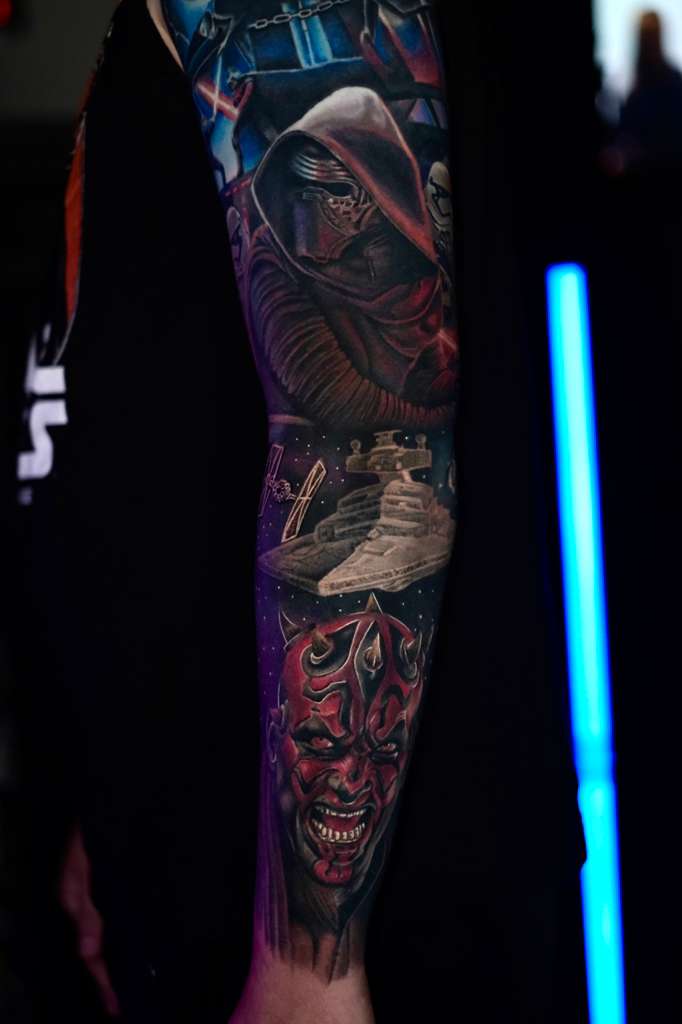 Color space-themed sleeve tattoo by Jonathan Cataño